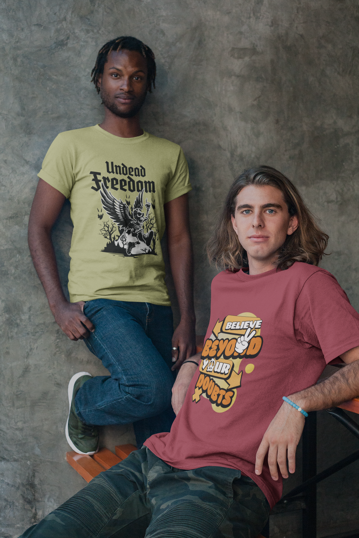 Two people wearing t-shirts with visible text and graphics against a textured wall.