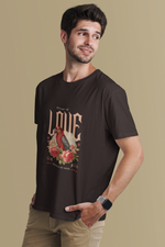 Man wearing a black t-shirt with a graphic design on a beige background