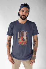 Man wearing a navy t-shirt with a graphic design of two birds and text on a plain background
