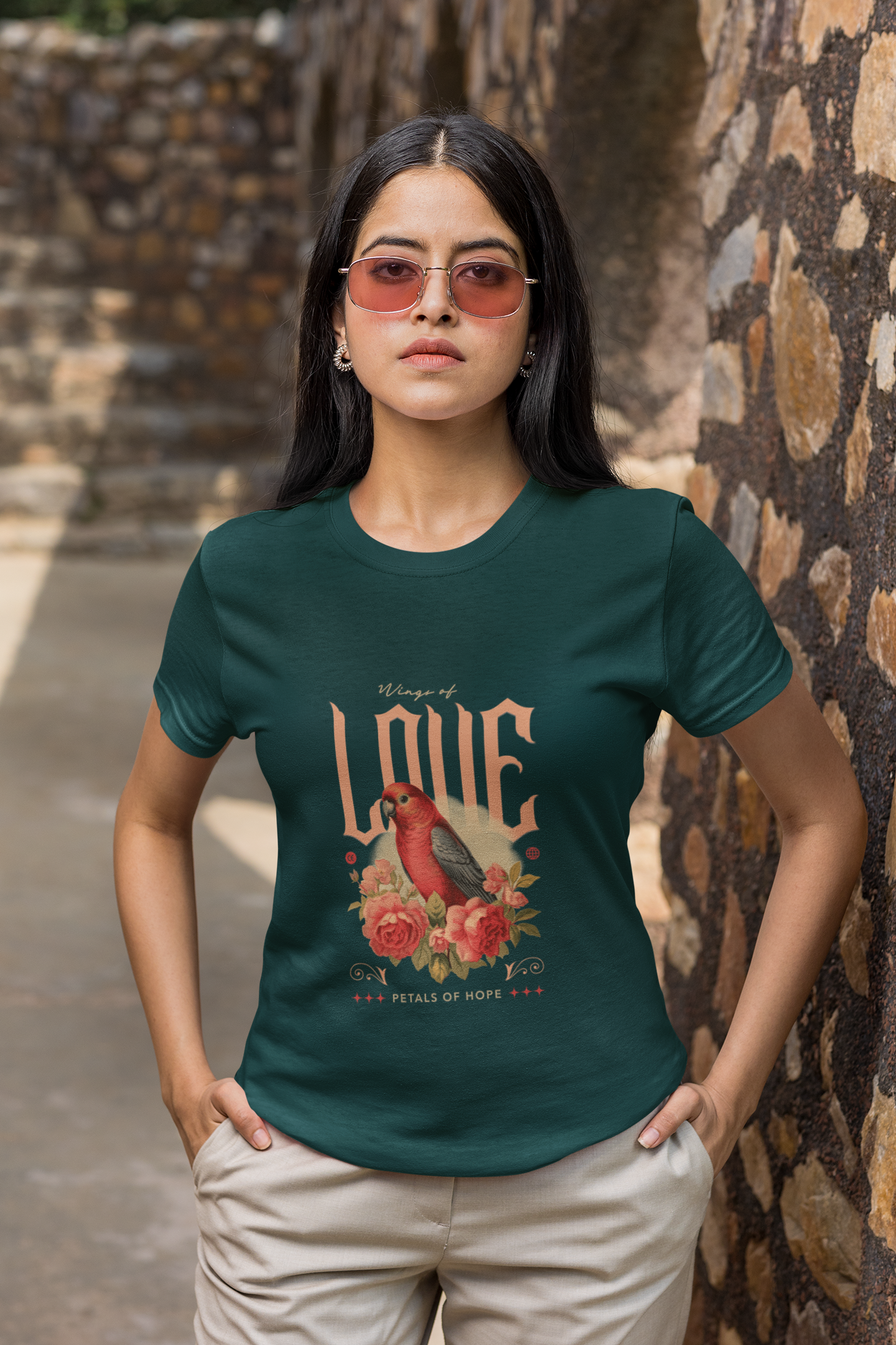 Woman wearing a green t-shirt with a graphic design in an outdoor setting