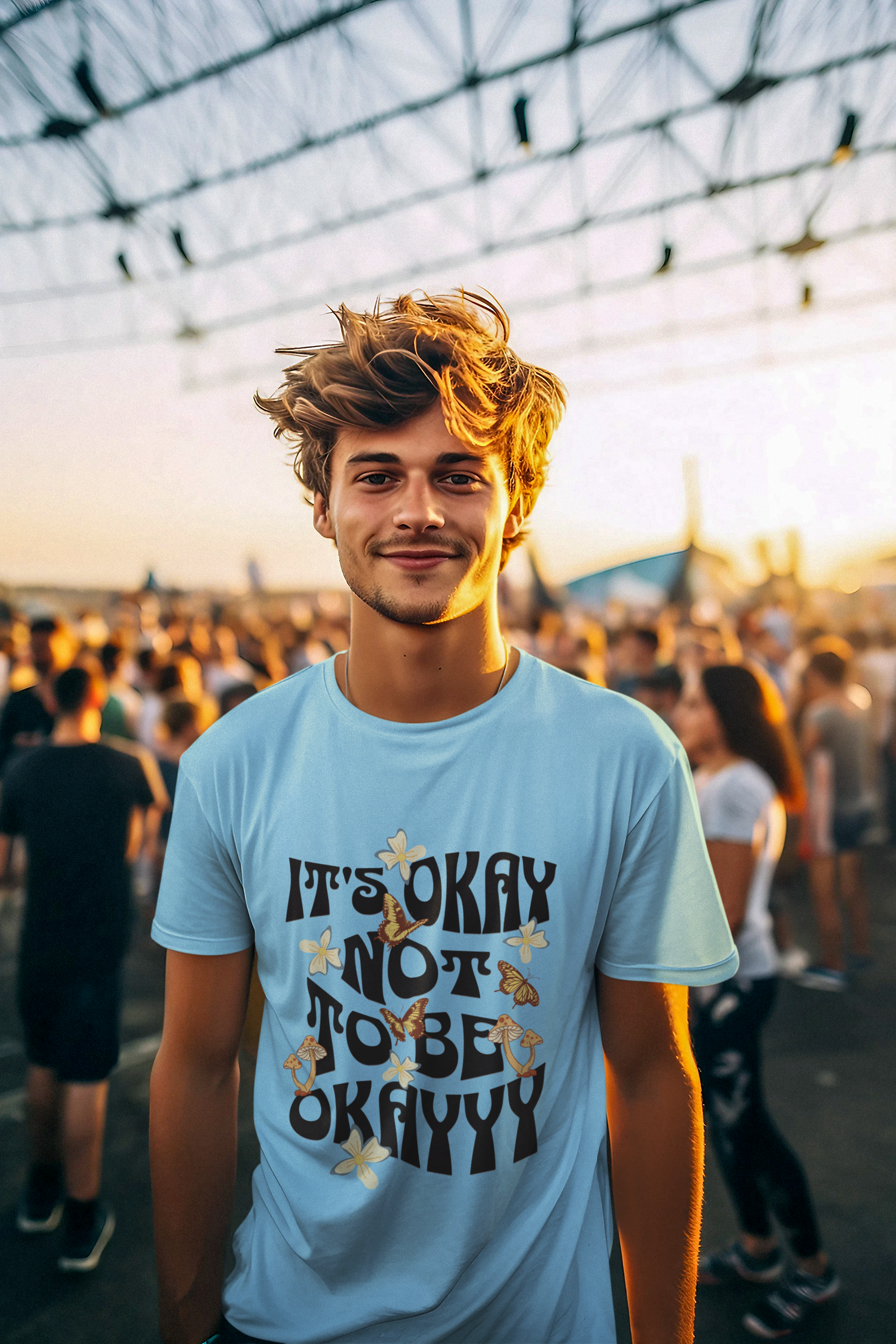 Man wearing a light blue t-shirt with text at an outdoor event.