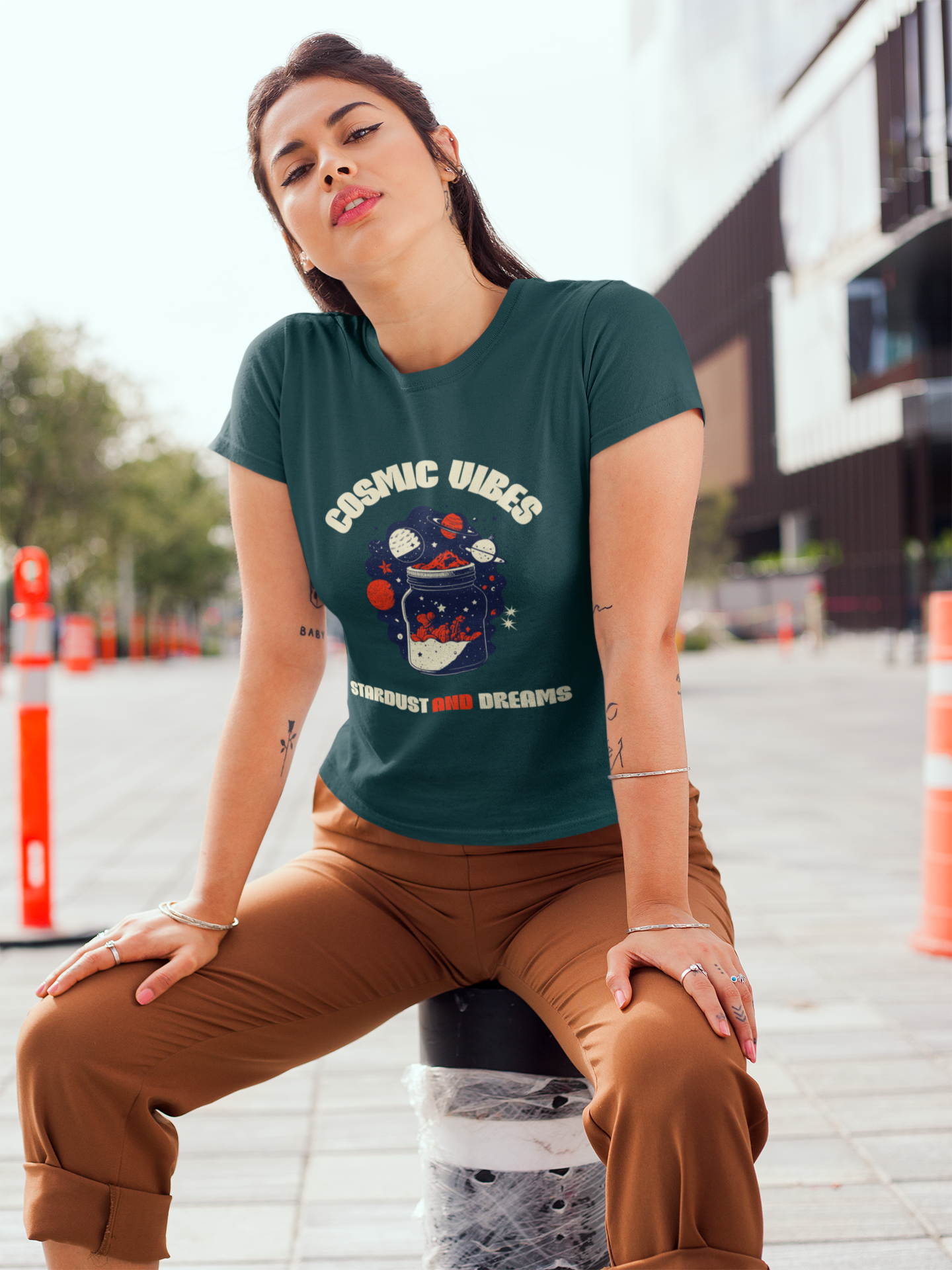 Person wearing a green t-shirt with 'Cosmic Vibes' design outdoors.