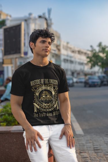 Man wearing a black t-shirt with text and graphics on a street background